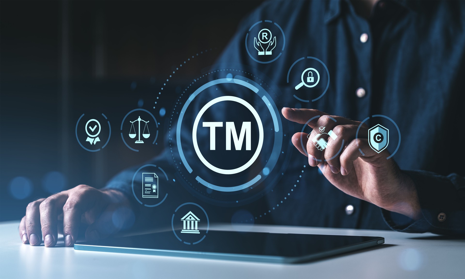 Trademark protection concept with digital interface icons and man using tablet device.